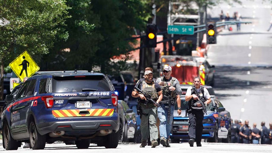 Law enforcement officers arrive near the scene of an active shooter on Wednesday, May 3, 2023 in Atlanta.