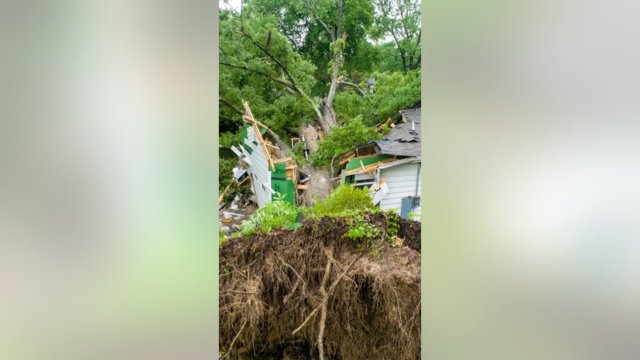 A tree crushes a house in Conway, Arkansas