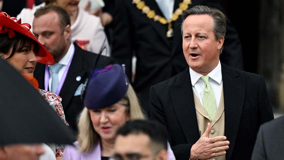 Former British Prime Minister David Cameron leaves Westminster Abbey following the coronation ceremony.