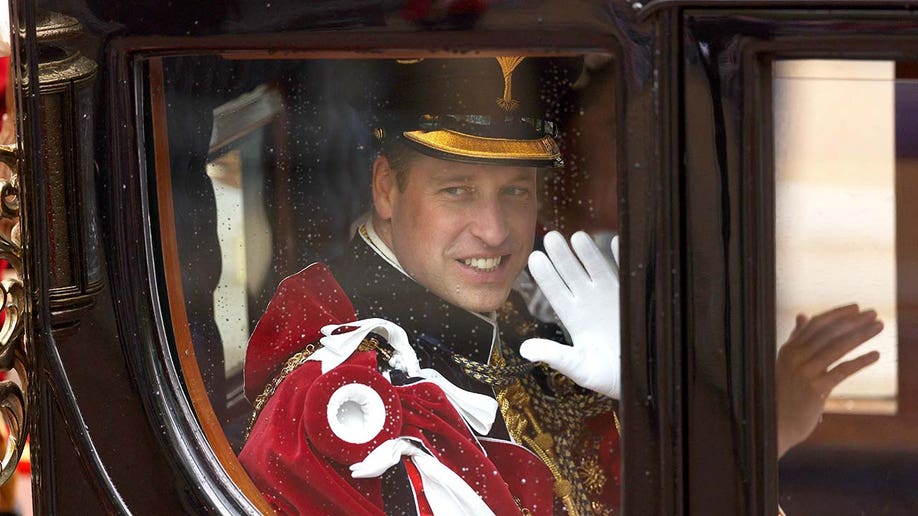 Prince William, Prince of Wales waves as he departs following the coronation ceremony for King Charles III and Queen Camilla.