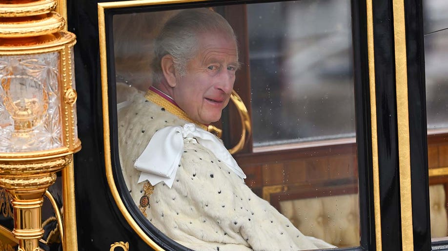 King Charles III and Queen Camilla are carried in the Diamond Jubilee State Coach