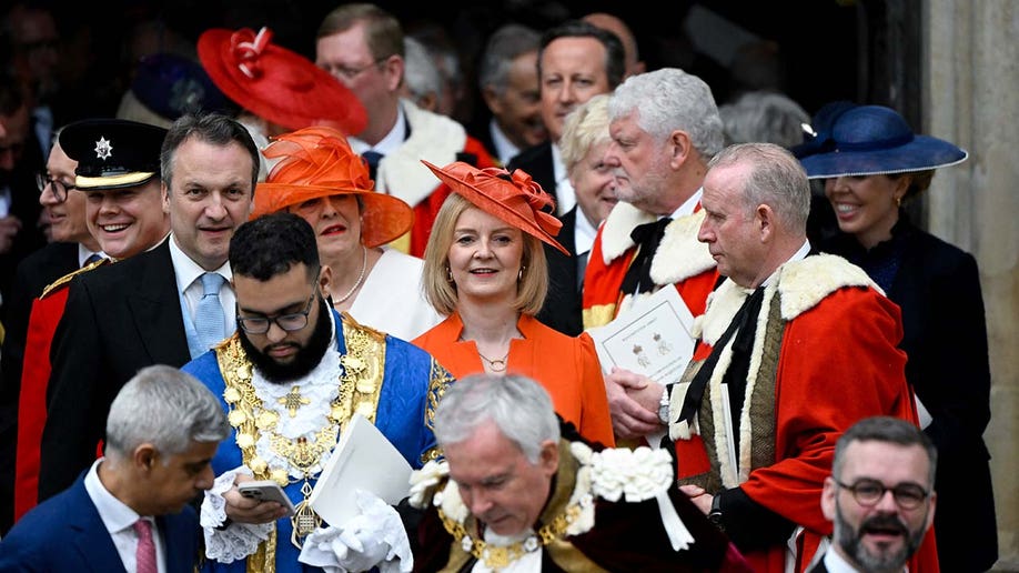 Former British Prime Minister Liz Truss and her husband Hugh O'Leary leave Westminster Abbey.