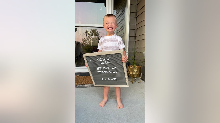 little boy with sign