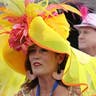 Woman wears a large yellow hat to the Kentucky Derby.