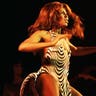 Tina Turner performing in a zebra print dress