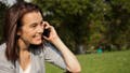 Woman smiles while she is talking on the phone