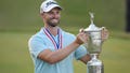 Wyndham Clark hoists the trophy after winning the 123rd U.S. Open Championship at the Los Angeles Country Club in Los Angeles on Sunday, June 18, 2023.