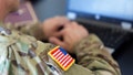 An American soldier works on a laptop