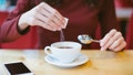 Picture of female hands with coffee and sugar