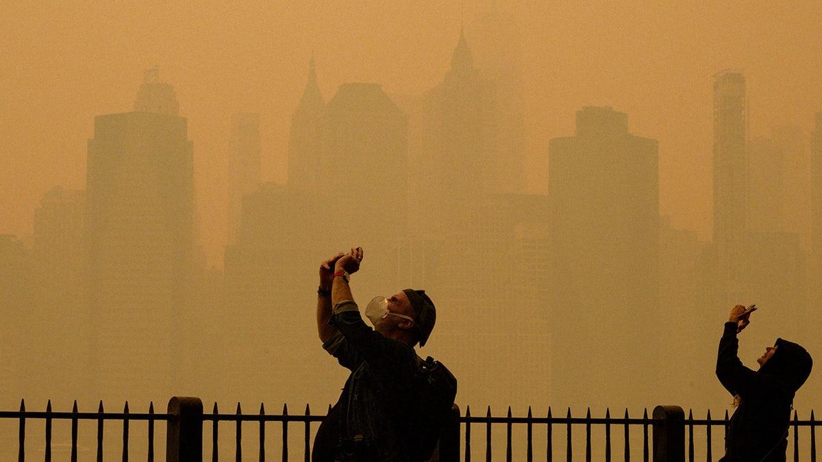 People take pictures of the haze