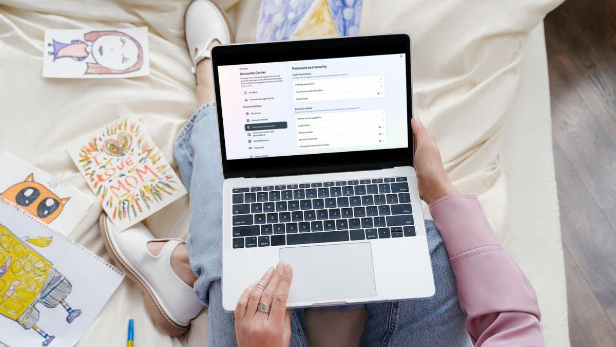 Woman sitting with a laptop on her lap.