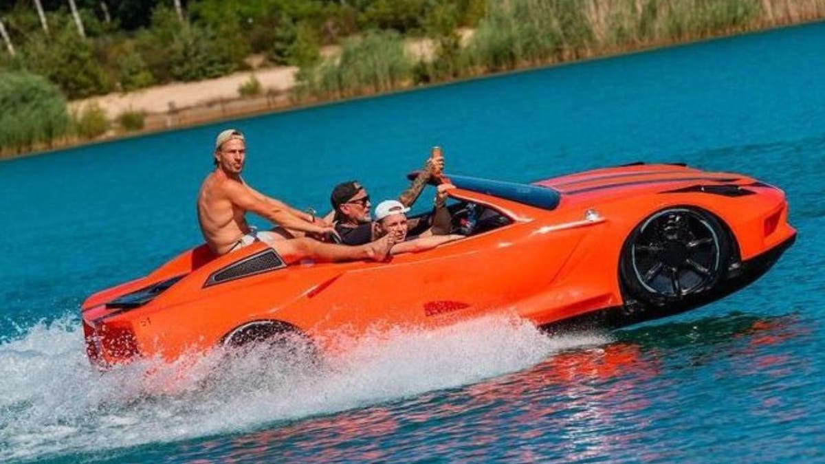 Photo of people jet skiing across the water.