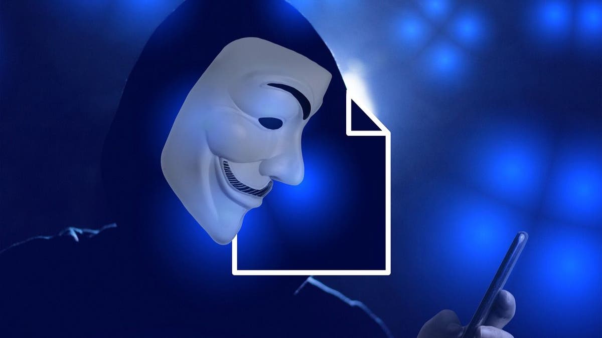 Photo of a hacker wearing a Guy Fawkes mask.