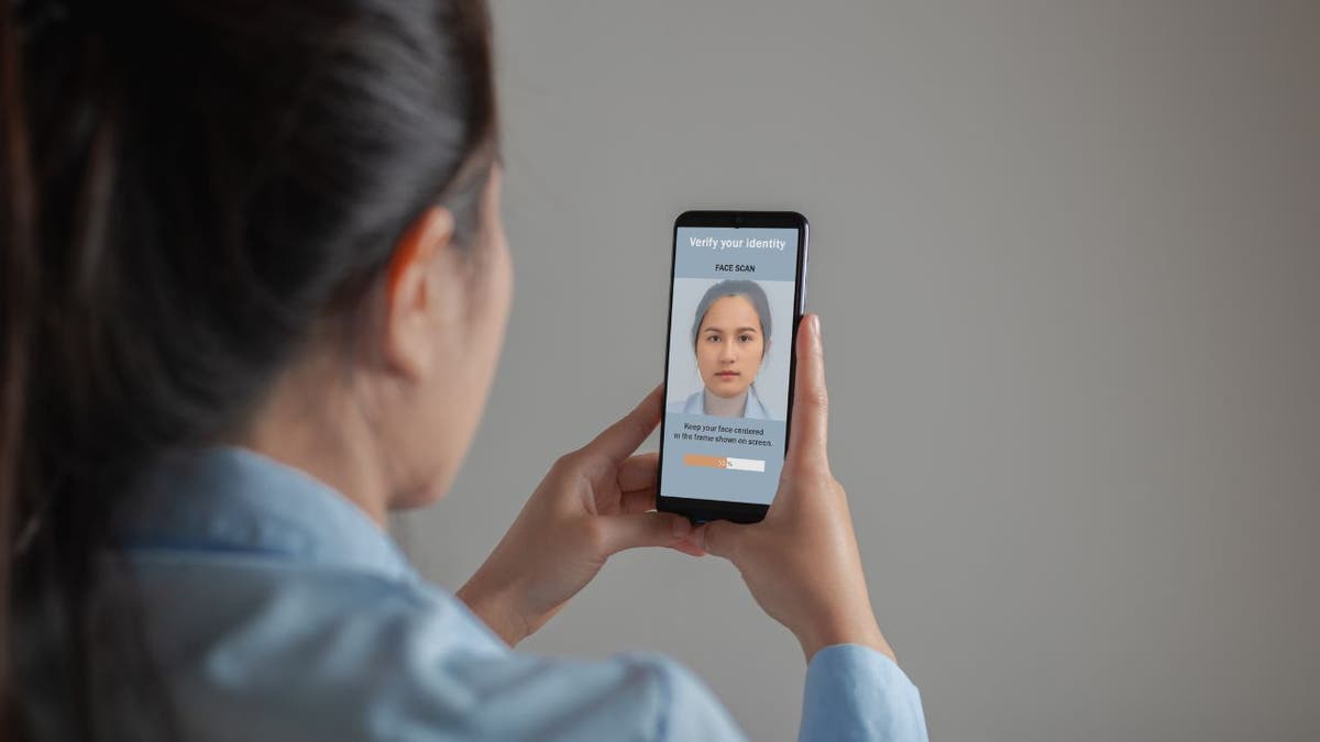 Photo of a woman holding up her phone.