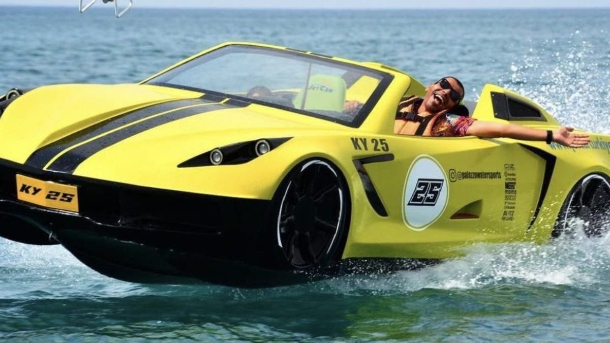 Man smiling while riding the jet ski.