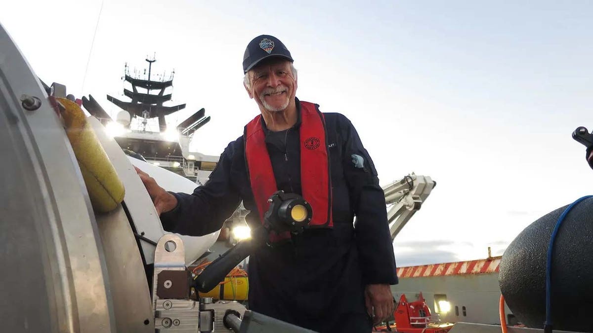 Missing mariner Paul-Henry Nargeolet poses next to OceanGate's Titan submersible in 2022