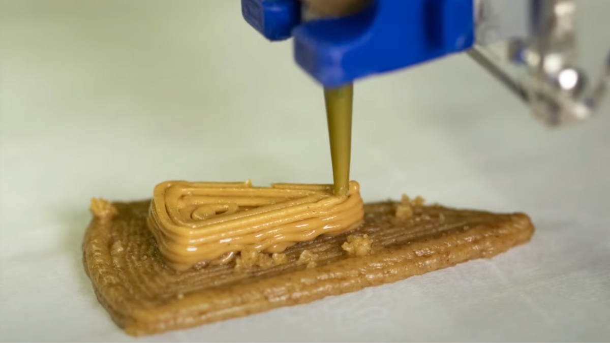 3-D printed graham cracker cheesecake being printed