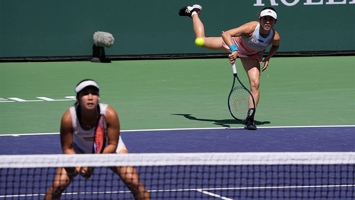 Miyu Kato, of Japan, right, serves behind her partner Aldila Sutjiadi, of Indonesia, as they play against Beatriz Haddad Maia, of Brazil, and Laura Siegemund, of Germany, in a doubles semifinal match at the BNP Paribas Open tennis tournament Friday, March 17, 2023, in Indian Wells, California.