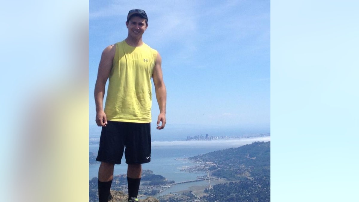 Matthew Nilo poses near a cliff overlooking San Francisco