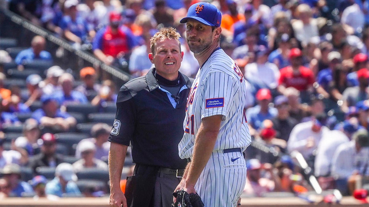 Max Scherzer speaks with the home plate umpire