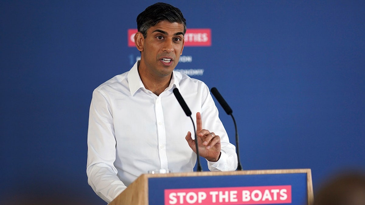 Rishi Sunak in front of stop the boats podium