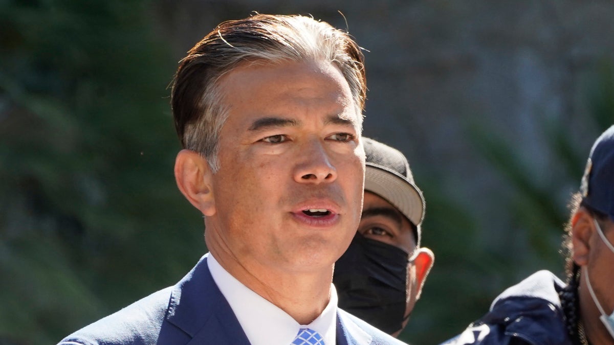 California AG speaks to reporters wearing a suit
