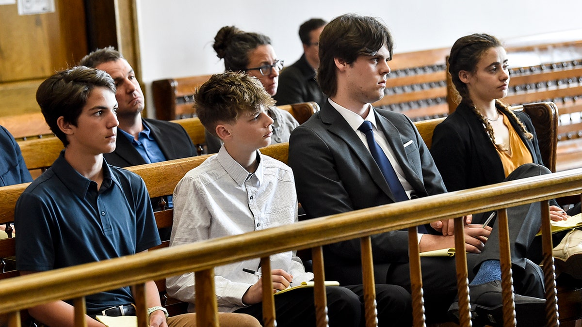 Several teens sitting in court