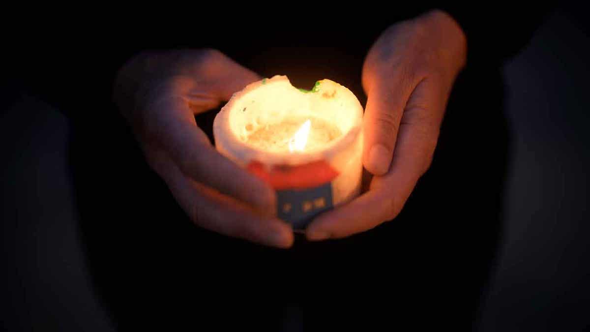 Candle being held