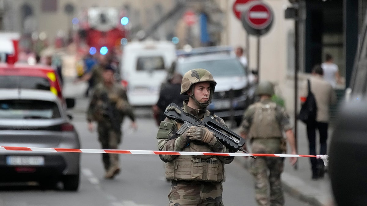 French soldier secures area by Paris explosion and fire
