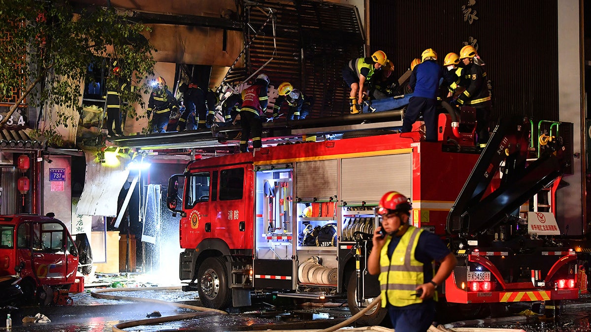 Chinese firefighters after restaurant explosion