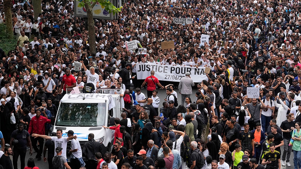 Protesters marching and holding signs