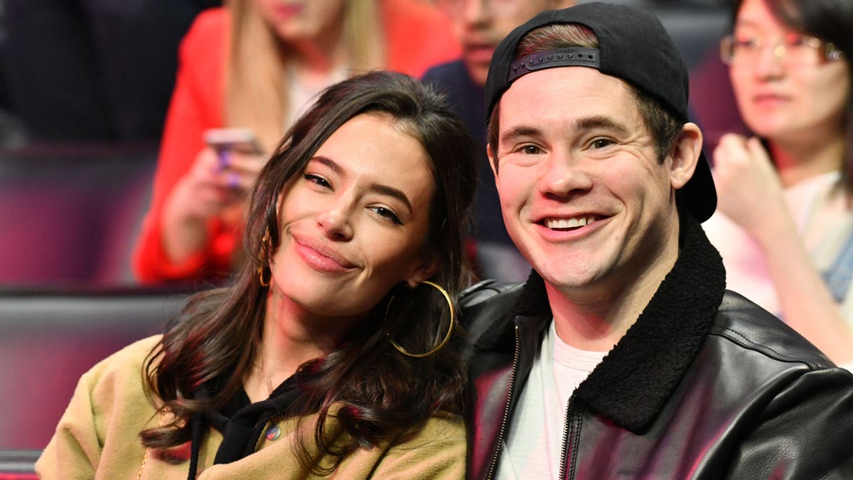 Adam DeVine and his wife attend a sports game