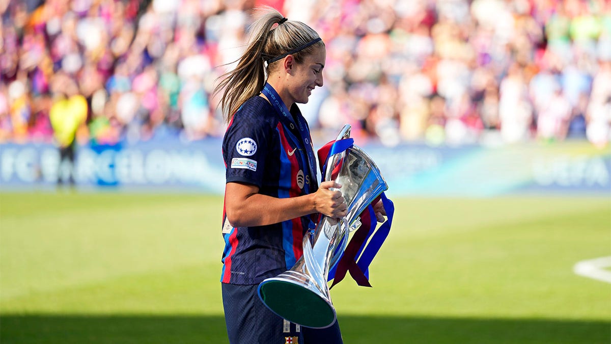 Alexia Putellas carries trophy