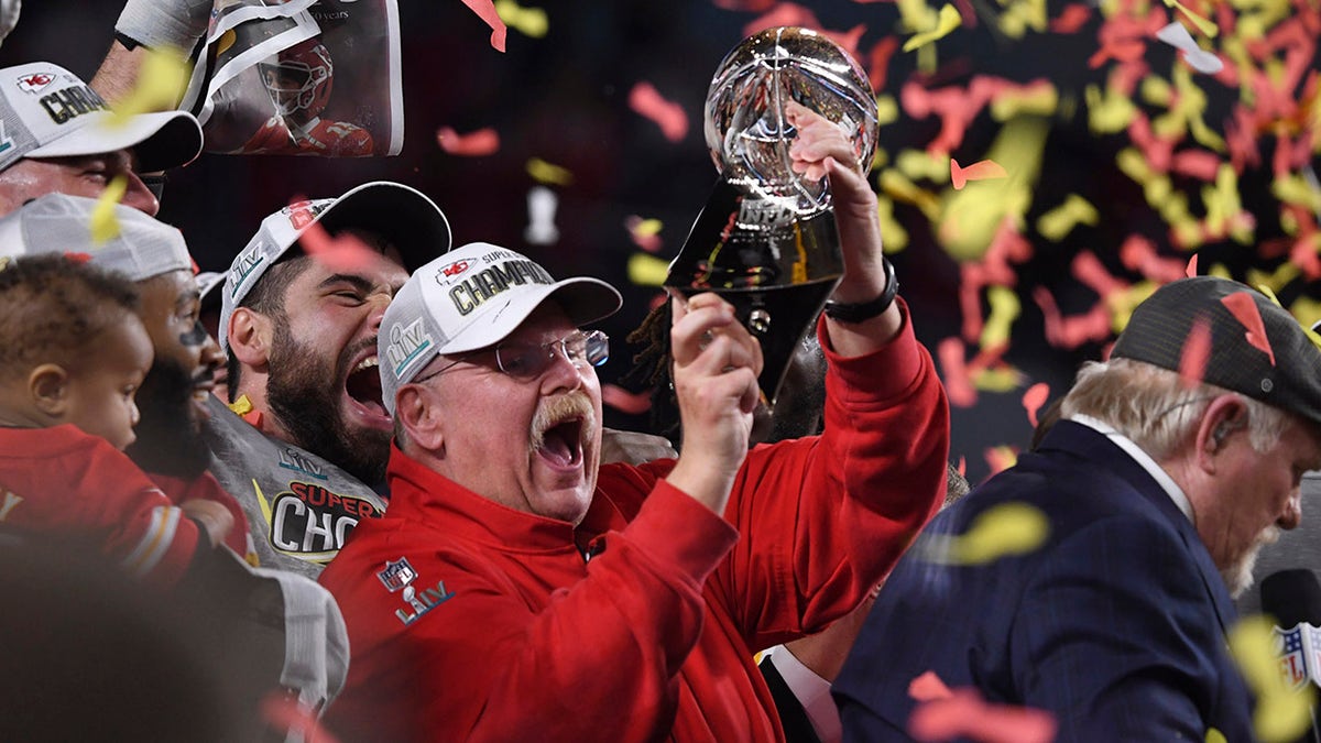 Andy Reid holds trophy
