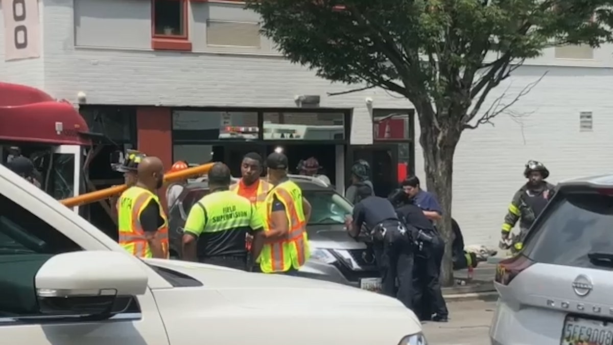 An image shows the MTA bus crashing into the building
