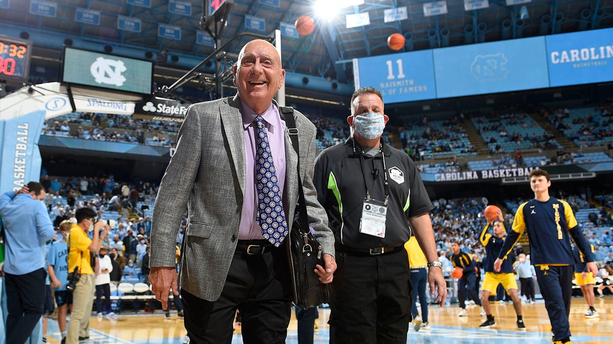 Dick Vitale walks on the basketball court before a game