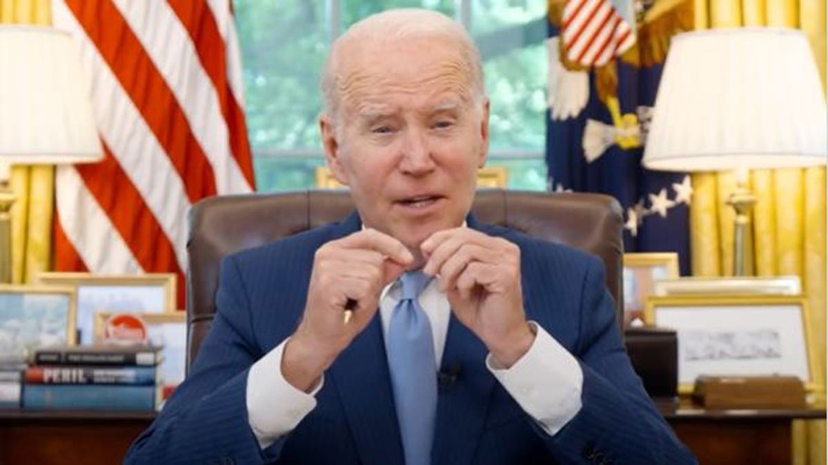 President Joe Biden sitting at desk in oval office