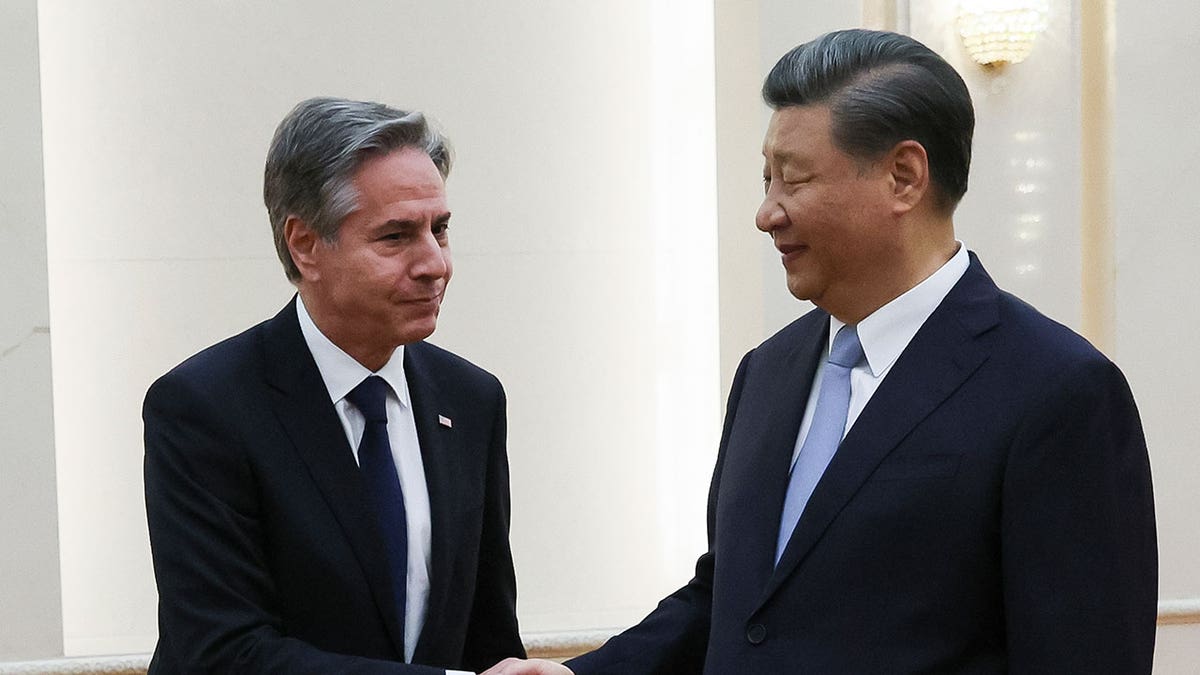 Blinken and Xi shake hands