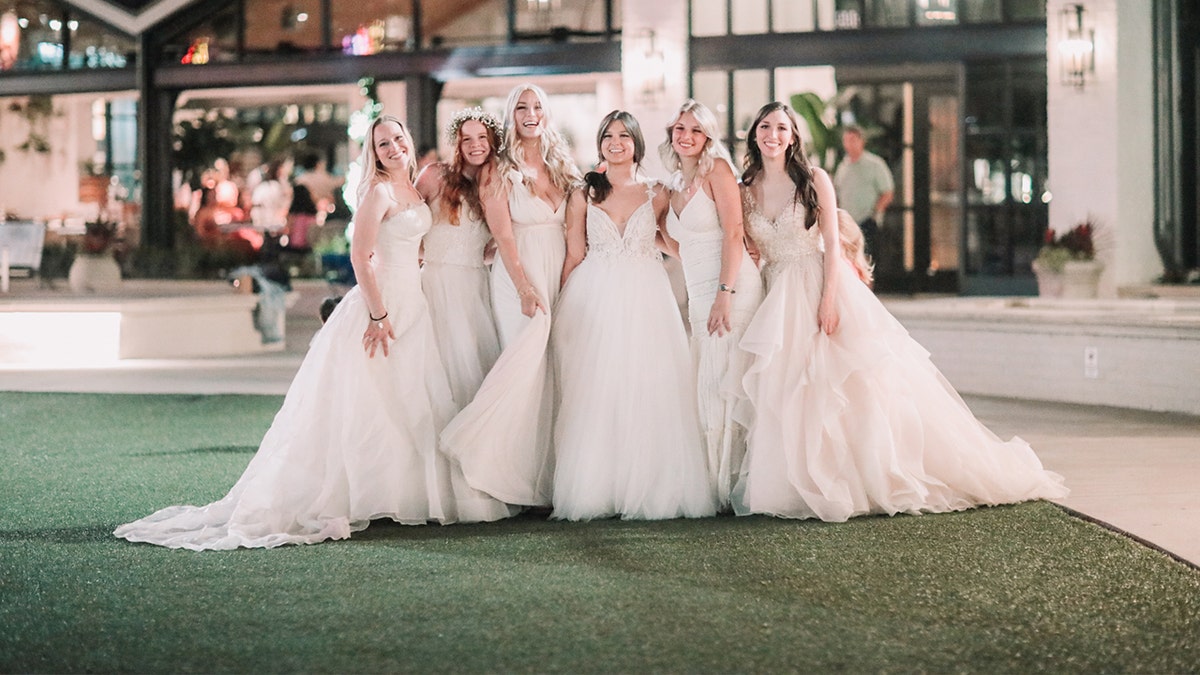 The 'Bonin Girls' pose for a photo while wearing white gowns.