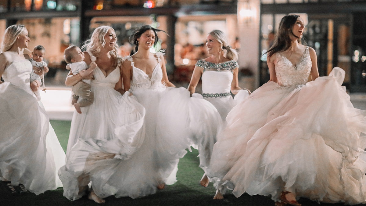 The 'Bonin Girls' have fun twirling in circles while wearing white gowns.
