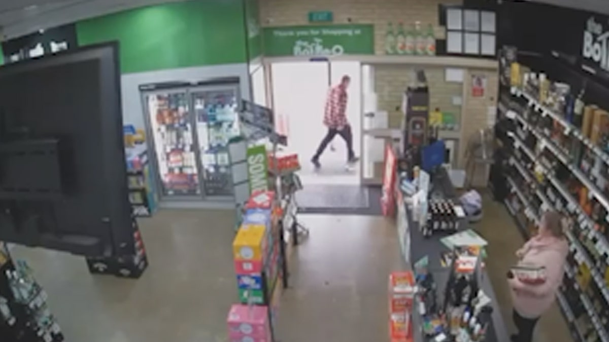 Man exits the store after cashier opens the door
