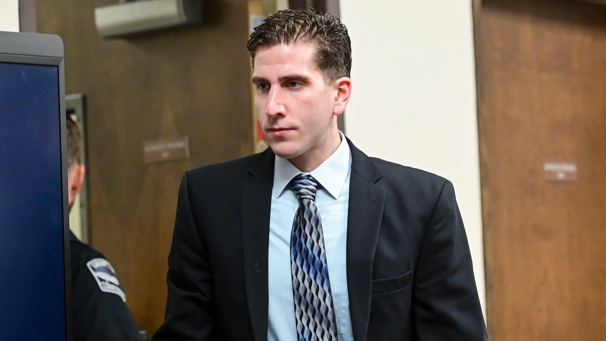 Bryan Kohberger enters a courtroom wearing dark suit and tie