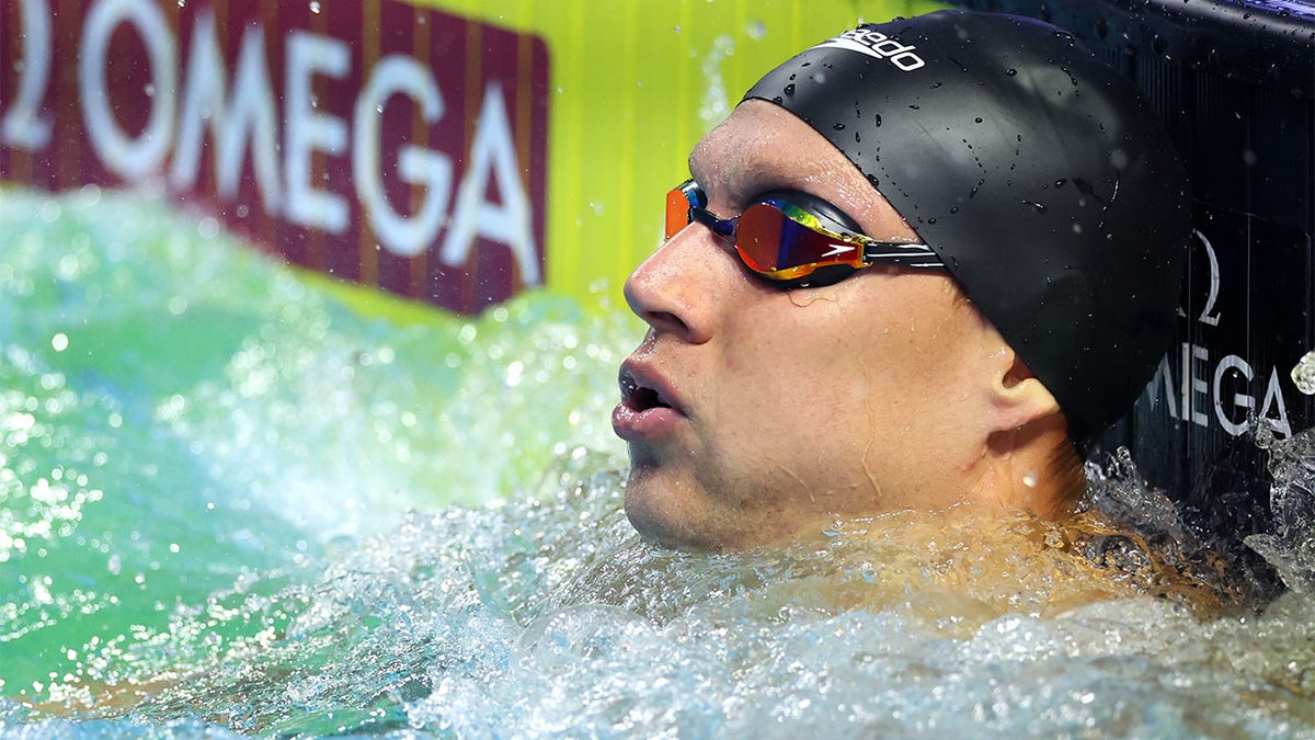 Caeleb Dressel looks on