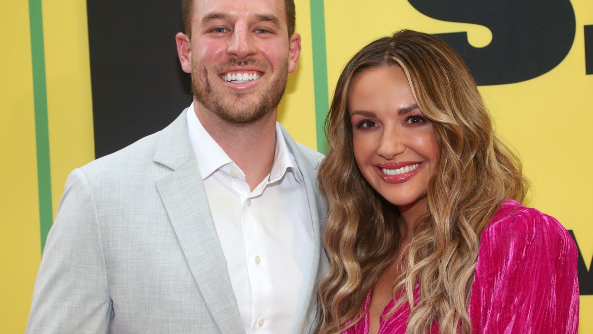 Carly Pearce smiling with Riley King at an event