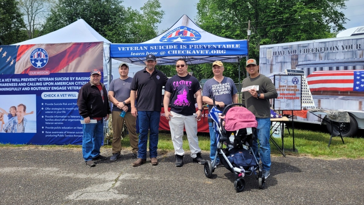 Michael R. Carmichael with fellow veterans at outdoor event