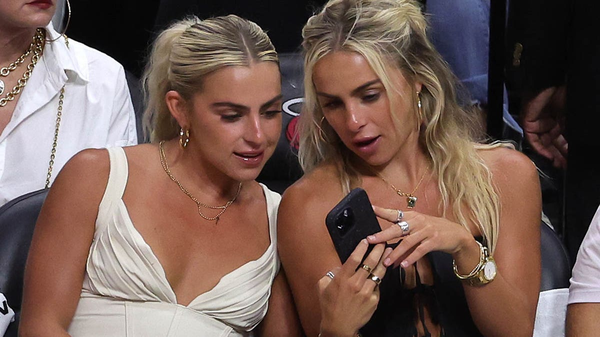 Cavinder twins look at their phone