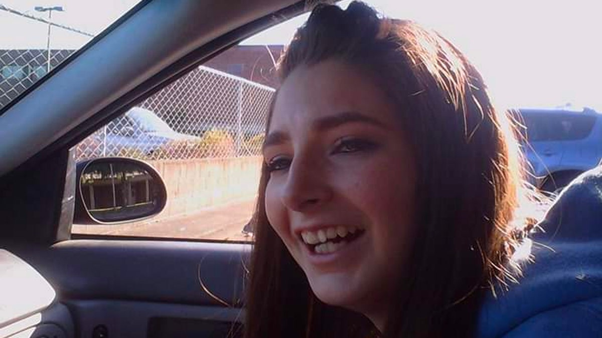 Charity Perry laughs in the passenger seat of a car