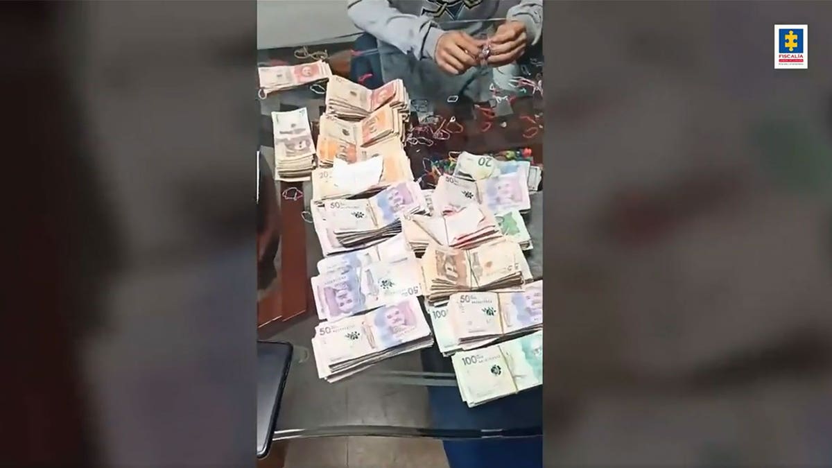 Stacks of money on a table that were seized in a raid in Colombia.