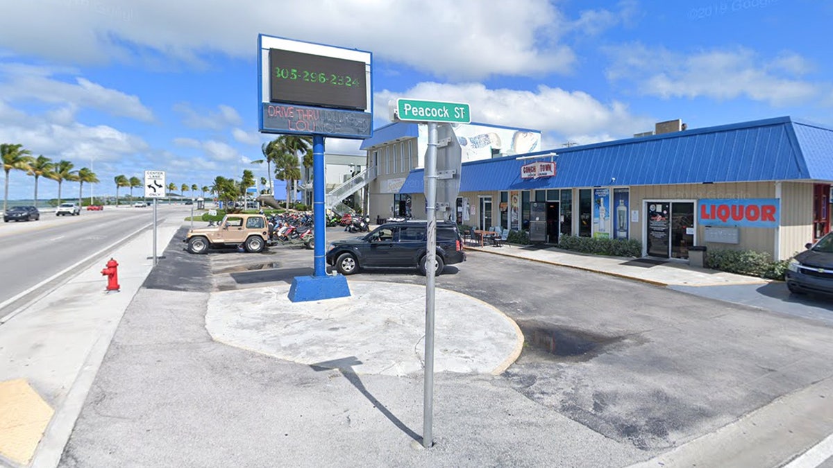 Conch Town Bar and Lounge shown across the street from the ocean.