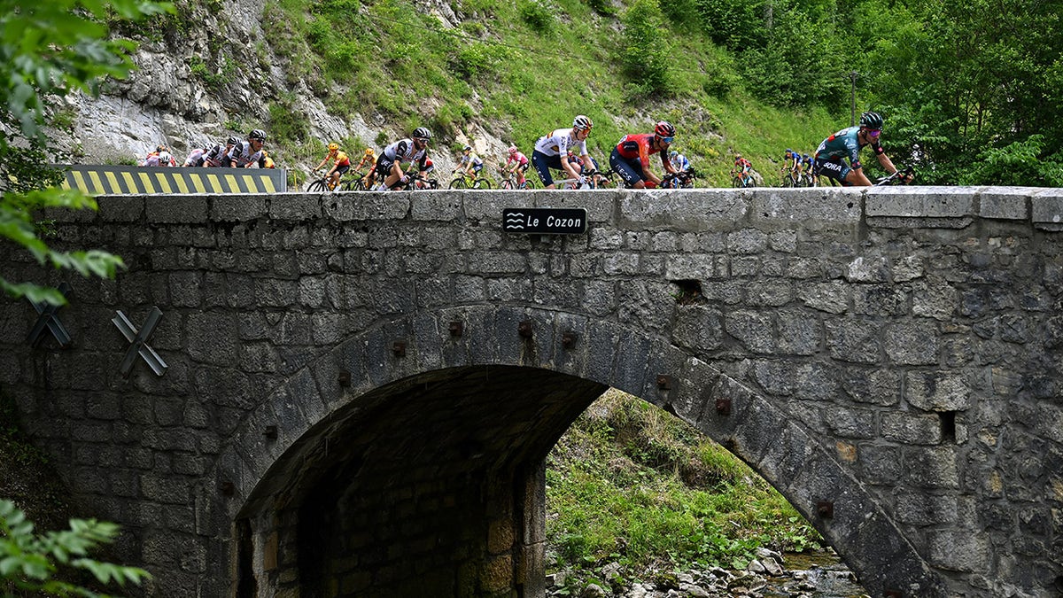 Cyclists travel over bridge